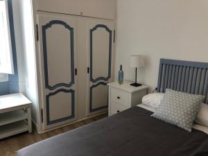 a bedroom with a bed and two glass doors at Vilamarlux II in Vilassar de Mar