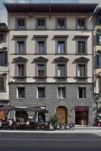a large building with windows on a city street at The Gallery 42 Guest House in Florence