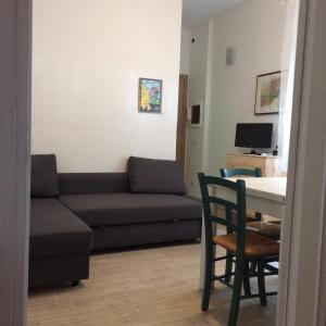 a living room with a couch and a table at CasaLella in Viareggio