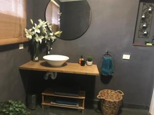 a bathroom with a sink and a mirror at Couple's Spa Retreat Resort Villa with complimentary champagne upon arrival in Cowes