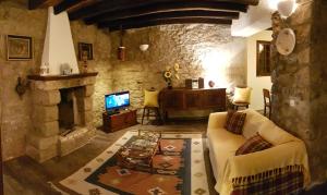 a living room with a couch and a fireplace at Casa da Camacha in Porto Santo