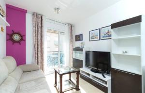 a living room with a couch and a tv at BEACH & DREAMS CALAFELL in Calafell