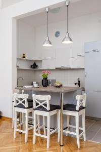 a kitchen with a table and four chairs at Old Town Clock Tower Apartment in Kotor