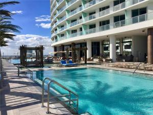 a large swimming pool in front of a building at Rent in LYFE Resort in Hollywood