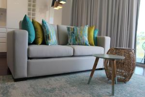 a living room with a couch with pillows and a table at Cascais Avenida Apartment in Cascais