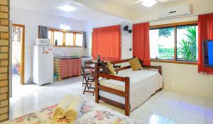 Un dormitorio con una cama y una cocina. en Adora Suites, en Abraão