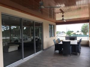 a dining room with a table and chairs on a patio at Blue Sky Apartment in Jurien Bay