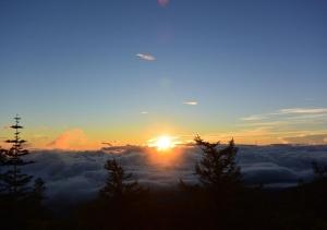 a sun setting over a field of clouds at Fujikyu Unjokaku in Narusawa +4 photos