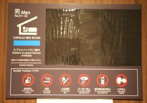a sign in a bathroom with some signs on it at Fujikyu Unjokaku in Narusawa