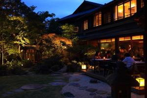 a group of people sitting at a restaurant at night at Nanzenji sando KIKUSUI in Kyoto +97 photos