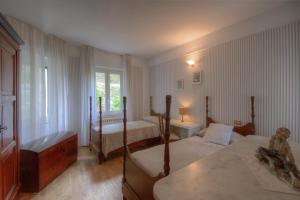 A bed or beds in a room at Appartamento in Villa a 5 KM dal mare