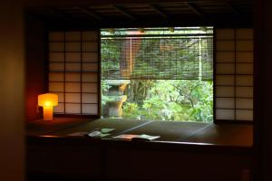 a bathroom with a bath tub and a window at Nanzenji sando KIKUSUI in Kyoto