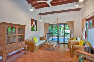 a living room with a couch and chairs at Tropical Family Retreat near Ya Nui Beach - Villa Nikkie in Nai Harn Beach
