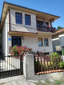 a house with a fence and flowers at Apartments Pendik in Ohrid