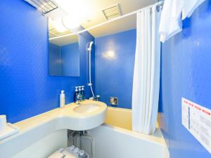 a blue bathroom with a sink and a shower at Hotel Abest Naha Kokusai Street in Naha