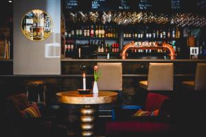 a bar with a table with a candle on it at Lilla Rådmannen in Stockholm