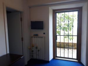 a room with a sliding glass door with a window at Stanze Blu in Subbiano