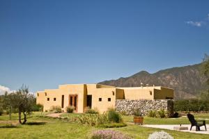 a large building with mountains in the background at Altalaluna Hotel Boutique & Spa in Cafayate