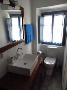 a bathroom with a white sink and a toilet at Magnificent traditional house in the centre of Naxos in Khalkíon