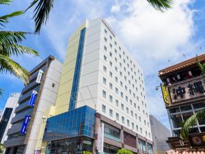 a tall white building on a city street at Hotel Abest Naha Kokusai Street in Naha