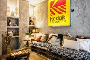 a living room with a couch and a sign on the wall at Kook Hotel Tarifa in Tarifa