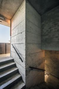 a staircase in a room with a brick wall at Kook Hotel Tarifa in Tarifa