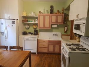 a kitchen with white appliances and a wooden table at Superior in Chicago