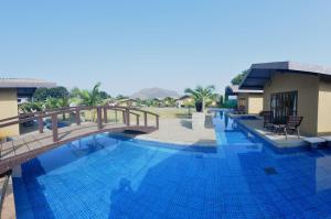 a swimming pool with a bridge in a resort at Treasure Island Resorts Lonavala in Lonavala