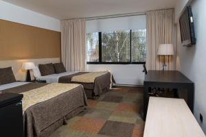 Posteľ alebo postele v izbe v ubytovaní Hotel Alborada