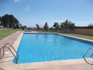 a large swimming pool with blue water at Resid. Balea Marítima in O Grove