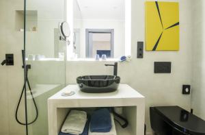 a bathroom with a black sink and a shower at Kook Hotel Tarifa in Tarifa