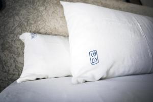 two white pillows sitting on top of a bed at Kook Hotel Tarifa in Tarifa