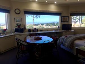 a bedroom with a table and a bed and a window at Llarrinda Bed & Breakfast in Foster