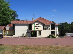 un gran edificio blanco con aparcamiento en Le Relais d'Etagnac, en Étagnac