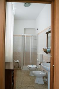a bathroom with two toilets and a sink and a shower at Il Convento in Trino