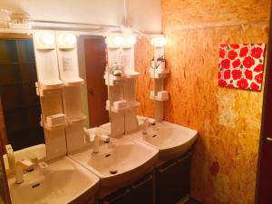 a bathroom with two sinks and two mirrors at Cloud Sharing Hotel Hakata 1 Guesthouse Dormitory in Fukuoka