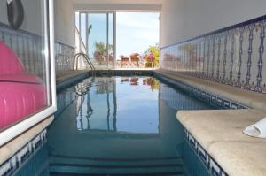 a swimming pool with water in the middle of a building at Casa Roble B&B in Cómpeta