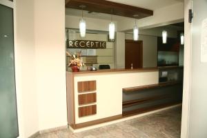 a lobby of a hotel with a reception counter at Euro House Hotel in Baia Mare