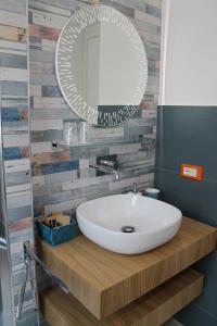 a bathroom with a white sink and a mirror at Arco del Sole in Palermo +33 photos