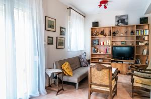 a living room with a couch and a tv at Next To The Sea - Apartment in Agia Triada