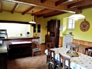a kitchen and dining room with a table and chairs at Talonno il frutteto in Invorio Inferiore +24 photos