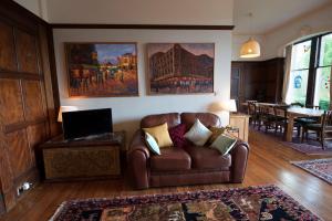 a living room with a couch and a table at Warriston Apartment at Holm Park in Moffat