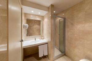 
a bathroom with a shower, sink, and toilet at Peralba Autohotel in Cornaredo

