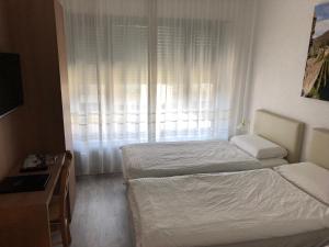 Letto o letti in una camera di Hotel Ceresio