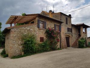 a brick house with flowers on the side of it at Sweet in Chianti in Tavarnelle Val di Pesa