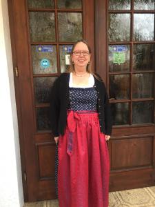 a woman is standing in front of a door at Tutzinger Hof in Tutzing