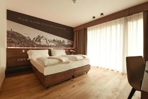 Posteľ alebo postele v izbe v ubytovaní Dolomeet Boutique Hotel