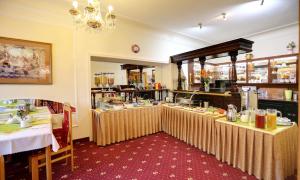 a restaurant with two tables and a buffet at Spa Hotel Purkyně in Karlovy Vary