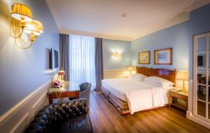 a hotel room with a bed and a couch at Grand Hotel Sitea in Turin +41 photos