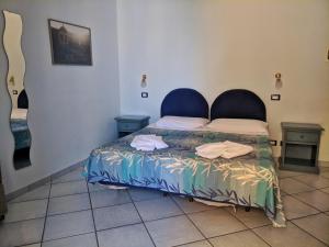 Postel nebo postele na pokoji v ubytování Hotel Mezzatorre